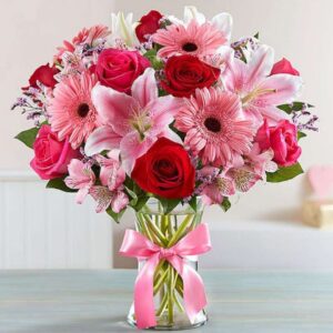 Blossom Reverie – Red and pink Roses, Pink Oriental Lilies, Gerbera, Daisies, Alstromeria in Glass Vase