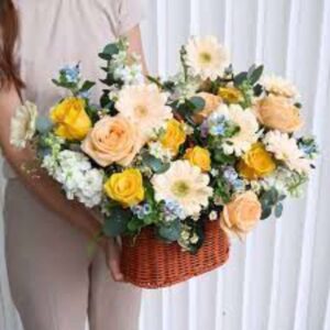 Pastel Poise – a curated mix of Roses, Gerberas, and Delphinium blooms in wicker basket